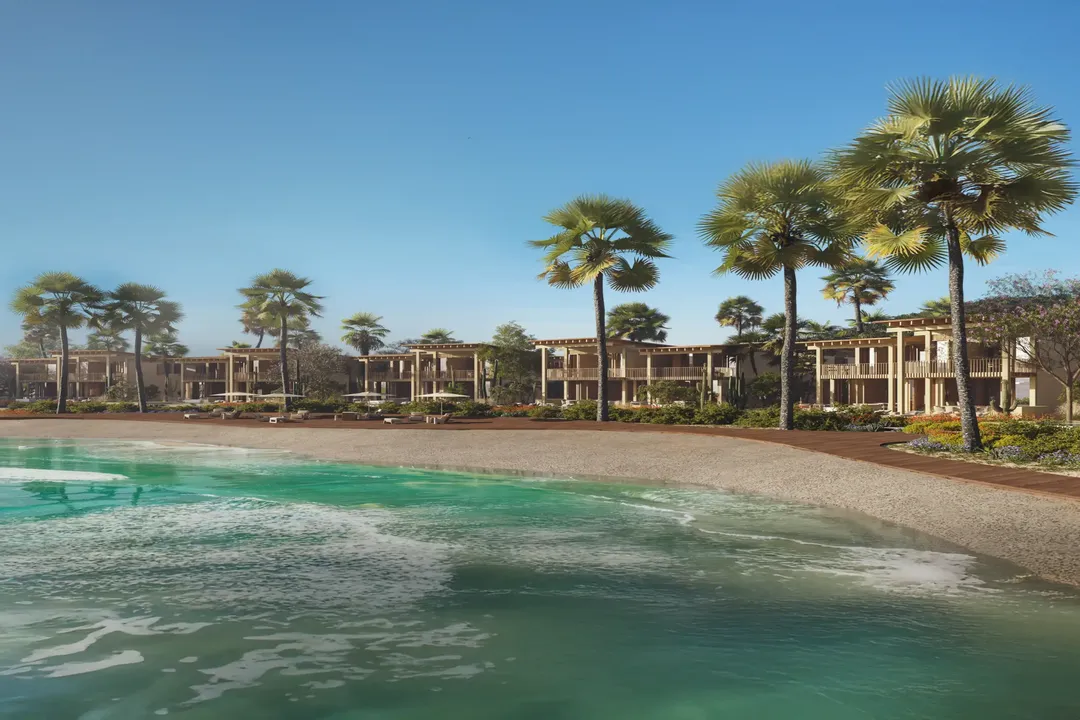 Luxury beachfront condos with turquoise water and palm trees